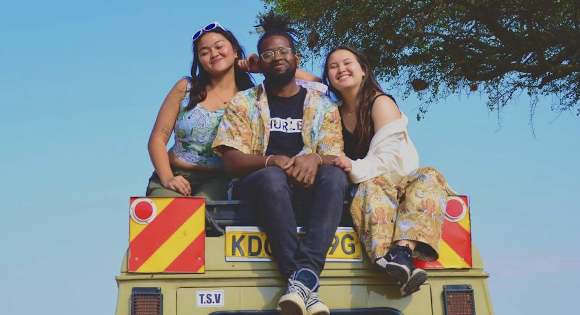 Research group sitting on top of a safari vehicle in Maasai Mara.